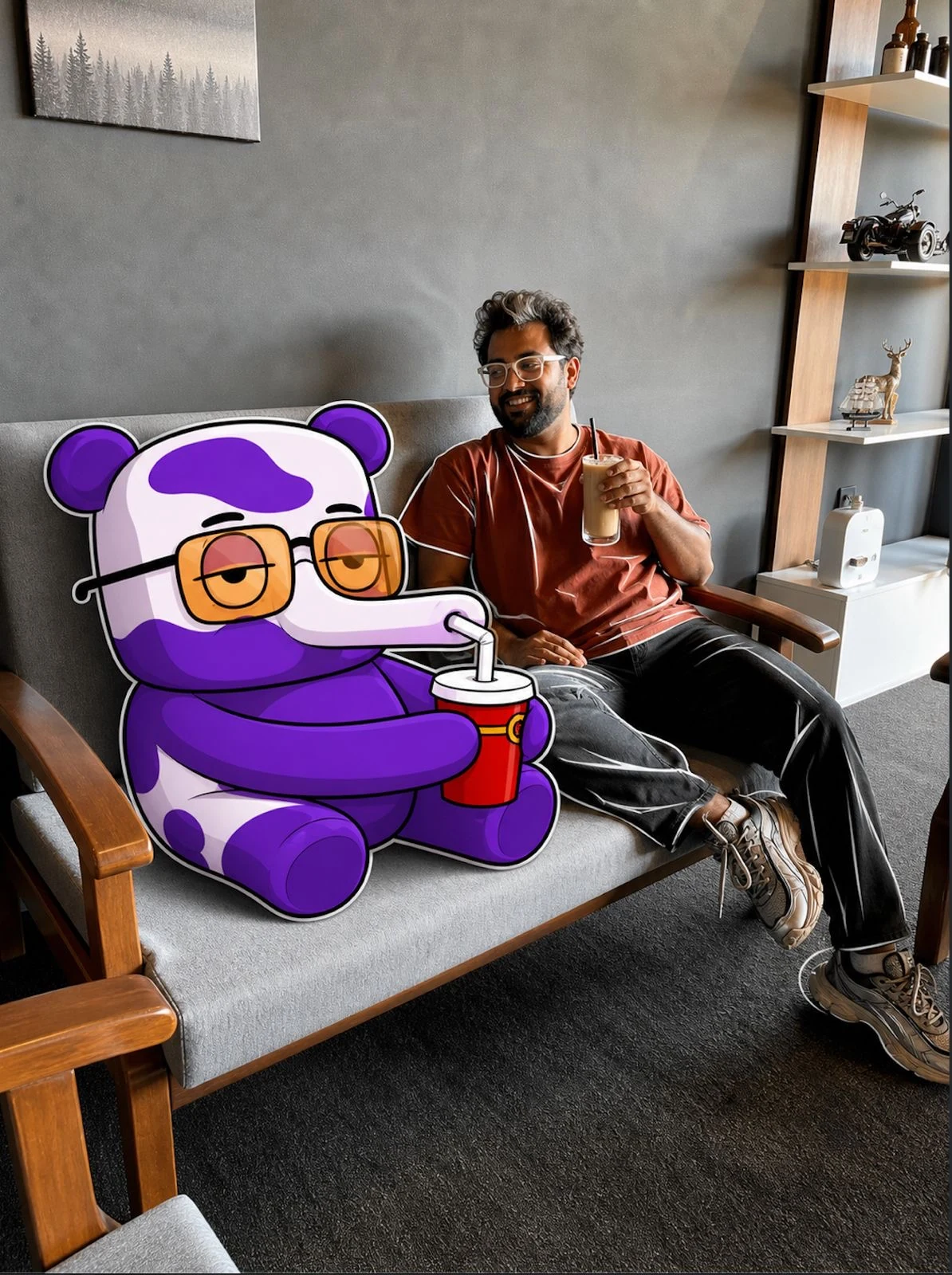 Purple Cow character relaxing with a creator in a café